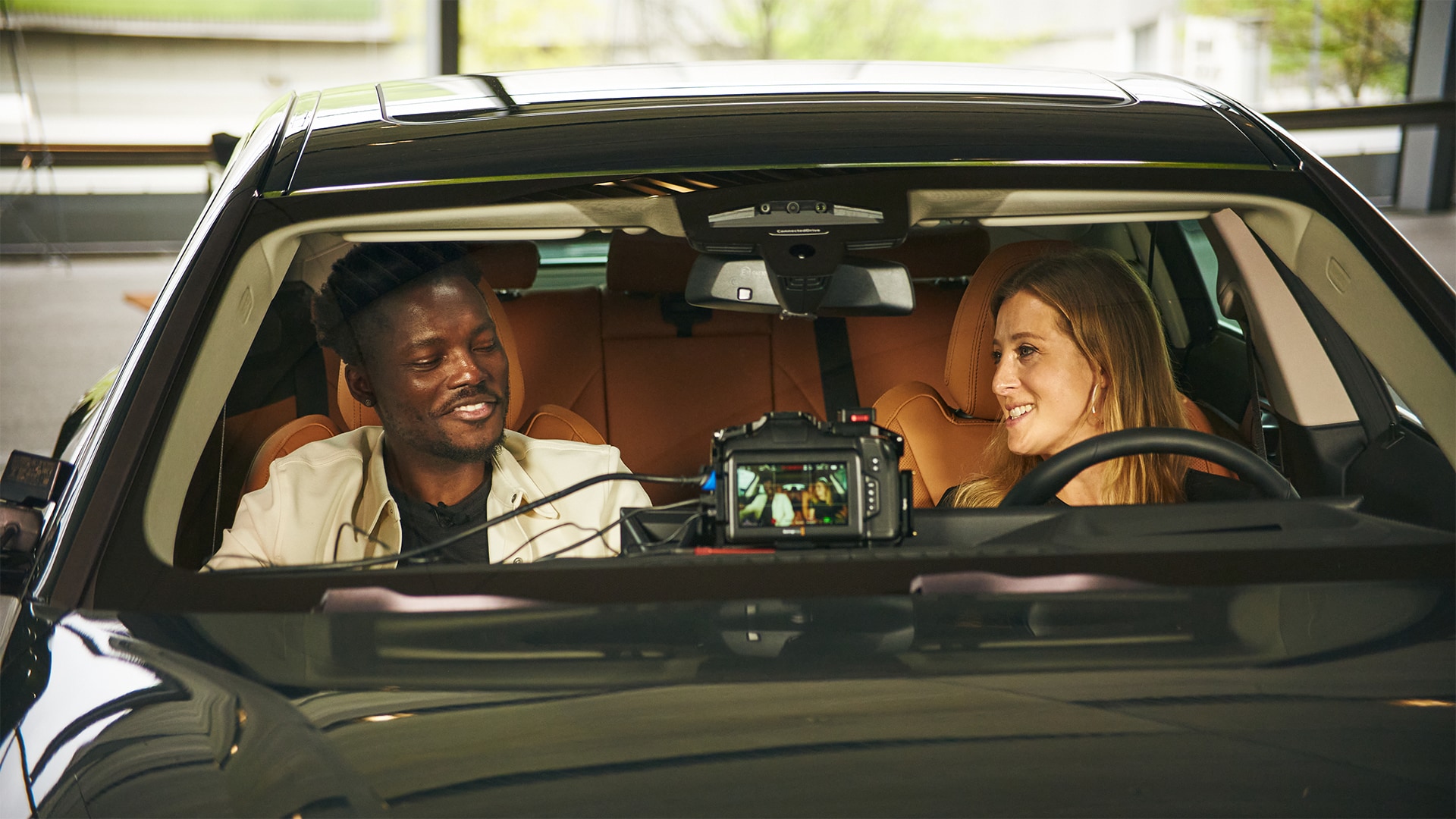 Tech influencer Tomi Adebayo and racing driver Charlie Martin together in the BMW i4 eDrive35.